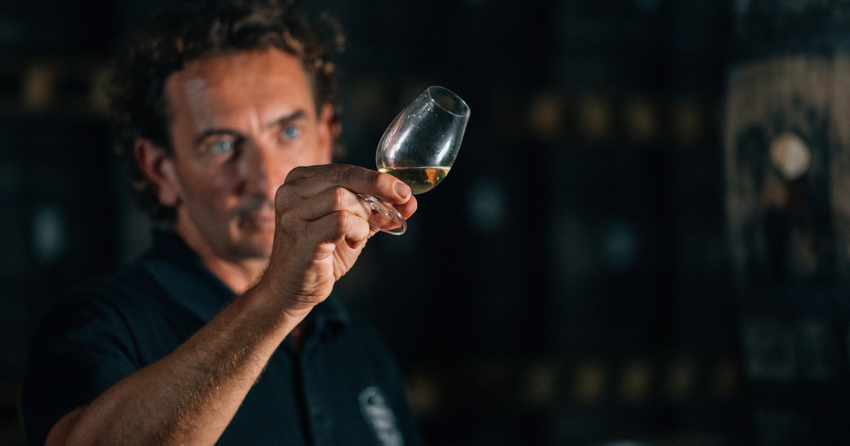 Pōkeno founder Matt Johns holding a Glencairn of whisky